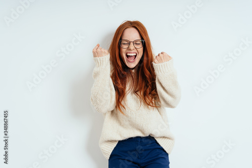 Slika na platnu Exultant young redhead woman cheering