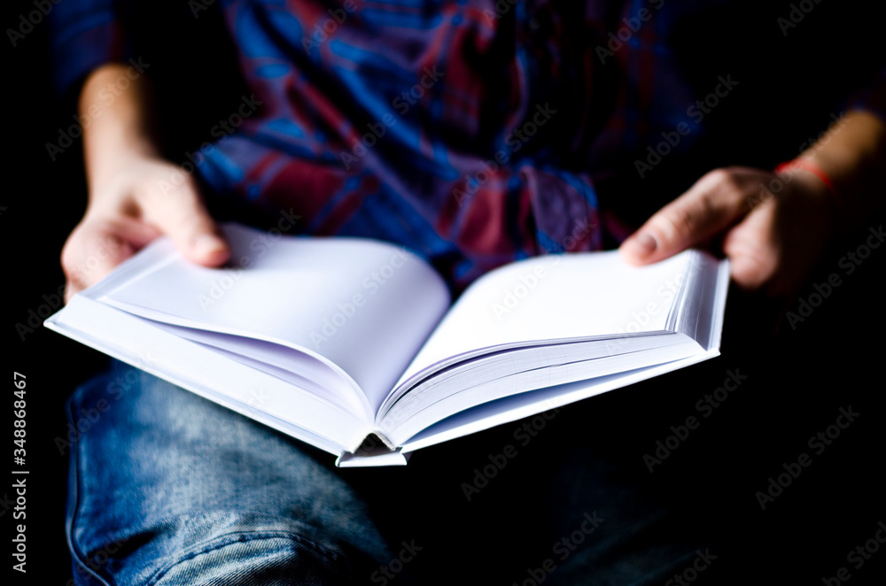 A Mockup white paper in the hands of a man in the home office A Mockup white paper in the hands of a man in the home office