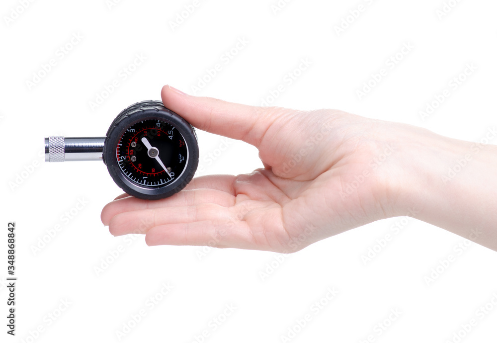 Automobile manometer tire gauge in hand on a white background isolation Automobile manometer tire gauge in hand on a white background isolation