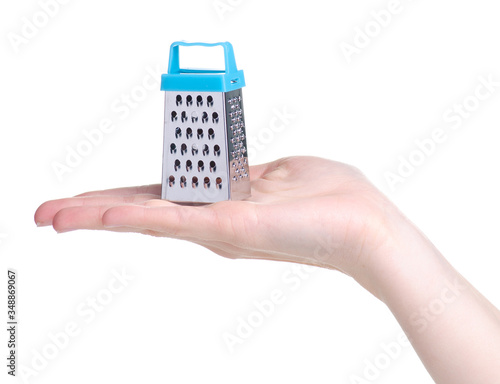 Blue mini grater in hand on white background isolation photo