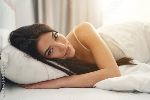 Tranquil Caucasian woman resting in her bedroom