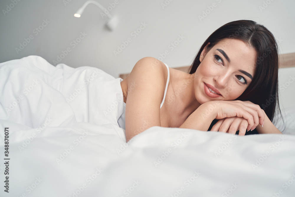 Obraz premium Peaceful young woman relaxing in her bedroom