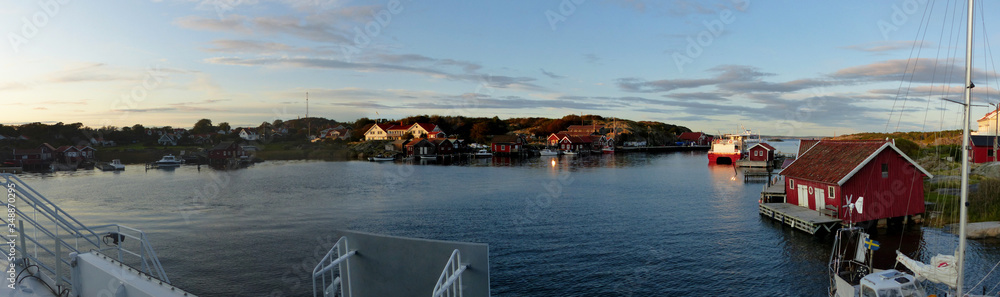 Panoramic view of the harbor, burgundy wooden houses, the landscapes and the coastline of the Koster,Sydkoster and Nordkoster islands. Kosterhavets National Park archipelago. Stromstad Bohuslan Sweden