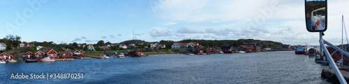 Panoramic view of the harbor, burgundy wooden houses, the landscapes and the coastline of the Koster,Sydkoster and Nordkoster islands. Kosterhavets National Park archipelago. Stromstad Bohuslan Sweden