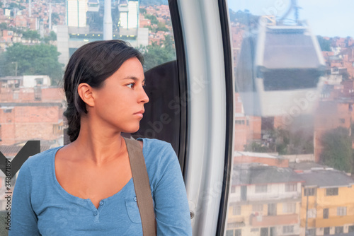 Free Download Woman in a blue t-shirt looking out of the window - GFXLoad