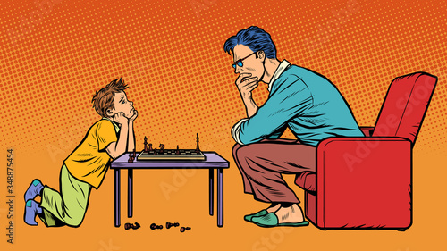 father and son play chess