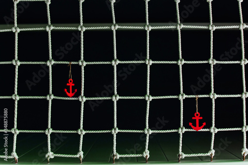 Marine seamless background with red anchor, intersecting lines and ornament of knots. photo