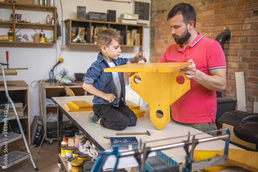 Father and Son Making a Birdhouse Father and Son Making a Birdhouse