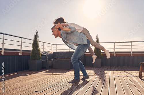 Wallpaper Mural Little cutie boy lying on the back of man Torontodigital.ca