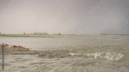 Water running over the floodplains of the river IJssel during flooding caused by high water levels in the river in Overijssel The Netherlands 
 photo