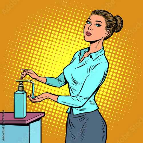 a woman uses a hand sanitizer