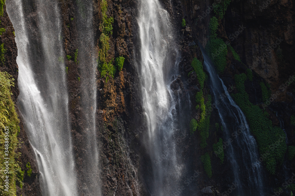 Close-up of the fresh and intense falling water in Tumpak Sewu Waterfall, in East Java, Indonesia.