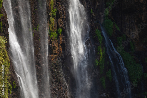 Close-up of the fresh and intense falling water in Tumpak Sewu Waterfall  in East Java  Indonesia.