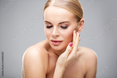 Beauty portrait of young woman with healthy skin and soft natural make up. Spa and care. Long beautiful blonde hair