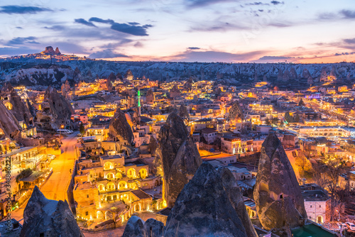 Night view of Goreme town with cave hotel built in rock formation in national park Goreme, Cappadocia, Turkey.
