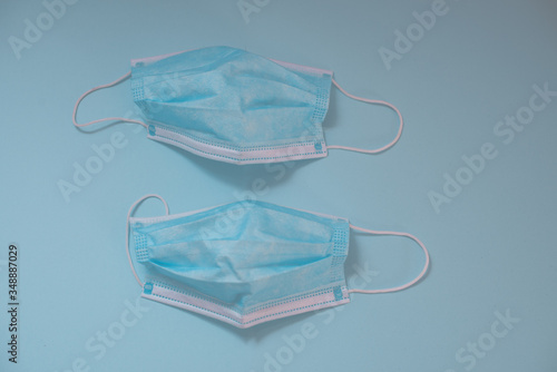 Surgical mask isolated against blue background shot from above