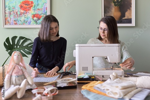 Family hand-made hobby and leisure, mother and daughter together sew
