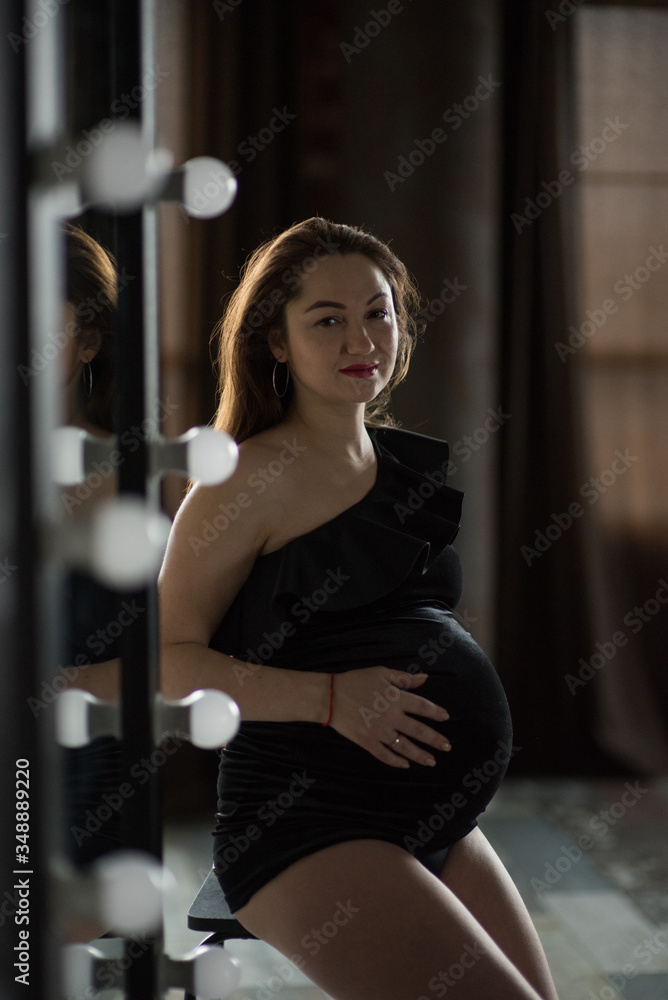 Pregnant women, photoshoot in dark key with black body Pregnant women, photoshoot in dark key with black body