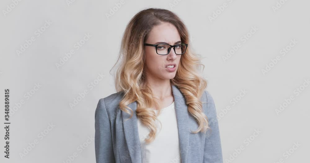 Discontent business woman covering nose with hand Discontent business woman covering nose with hand