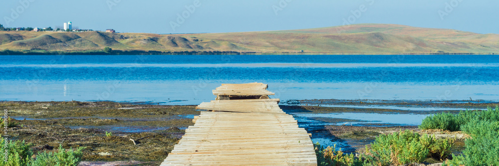 Old wooden jetty or pier at a lake or sea