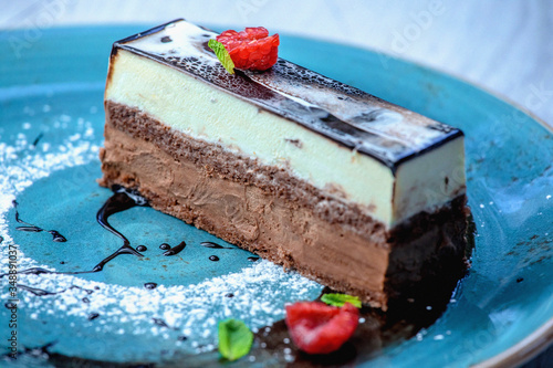 Delicate white and bitter chocolate mousses separated by a thin sponge cake 