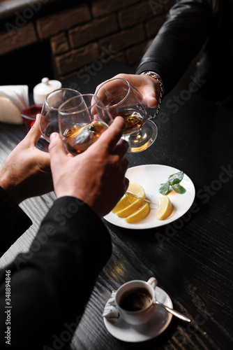 men with glasses of brandy together to celebrate the holiday
