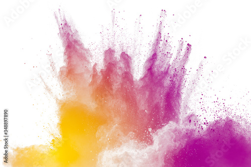 Purple particles explosion on white background. Freeze motion of purple dust splash on background.