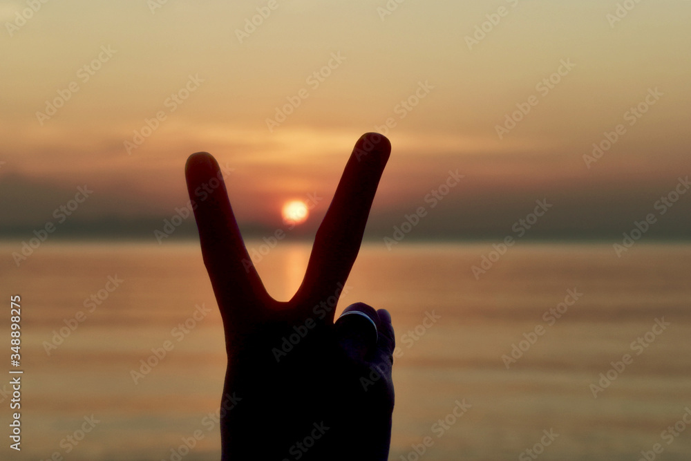 Hand form of two fingers at sunset sign language