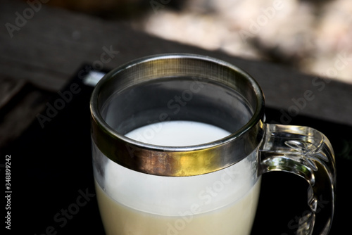 Fresh milk in glass on black background