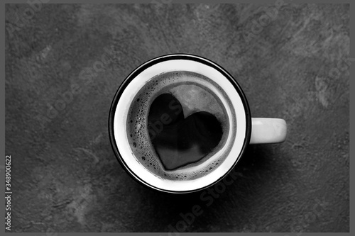 Top view coffee cup with heart sign on black background, romantic black and white photo