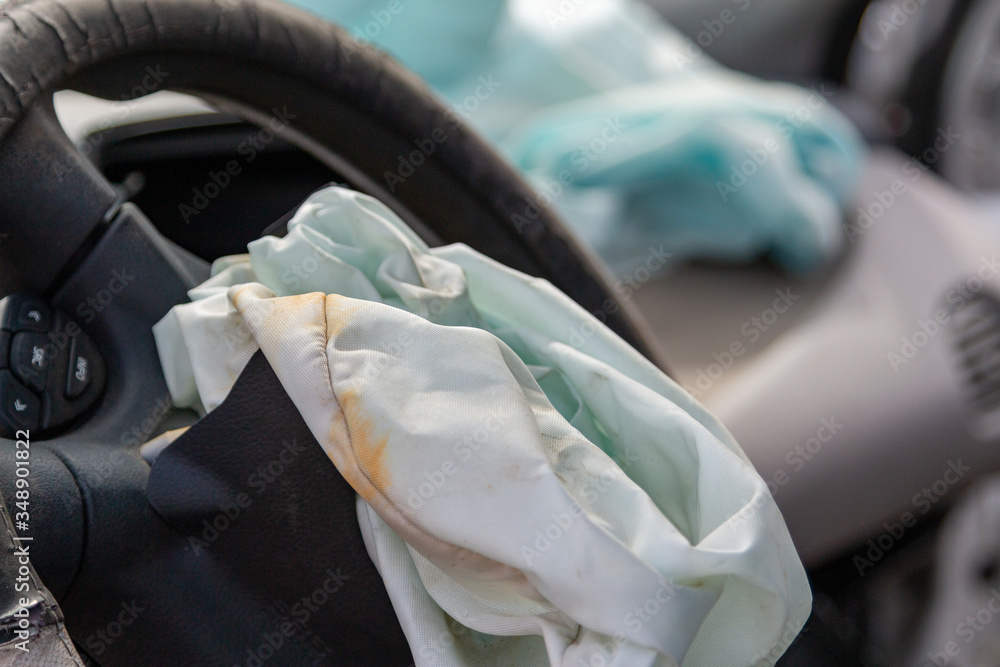 A front car airbag has deflated in a steering wheel from an accident. Car Crash