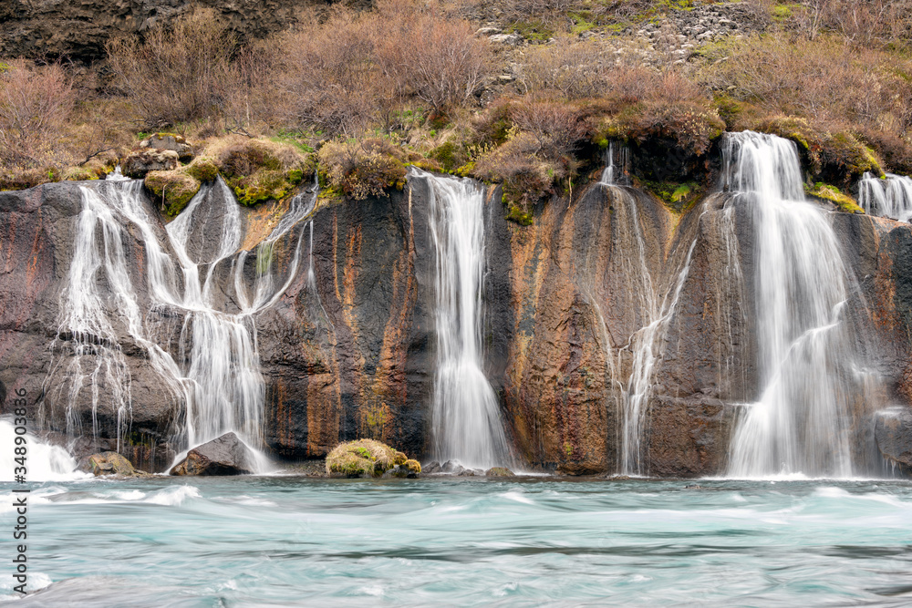 Naklejka premium Hraunfossar waterfall cascade in the Reykholt area in Iceland. Travelling, nature and holiday concept.