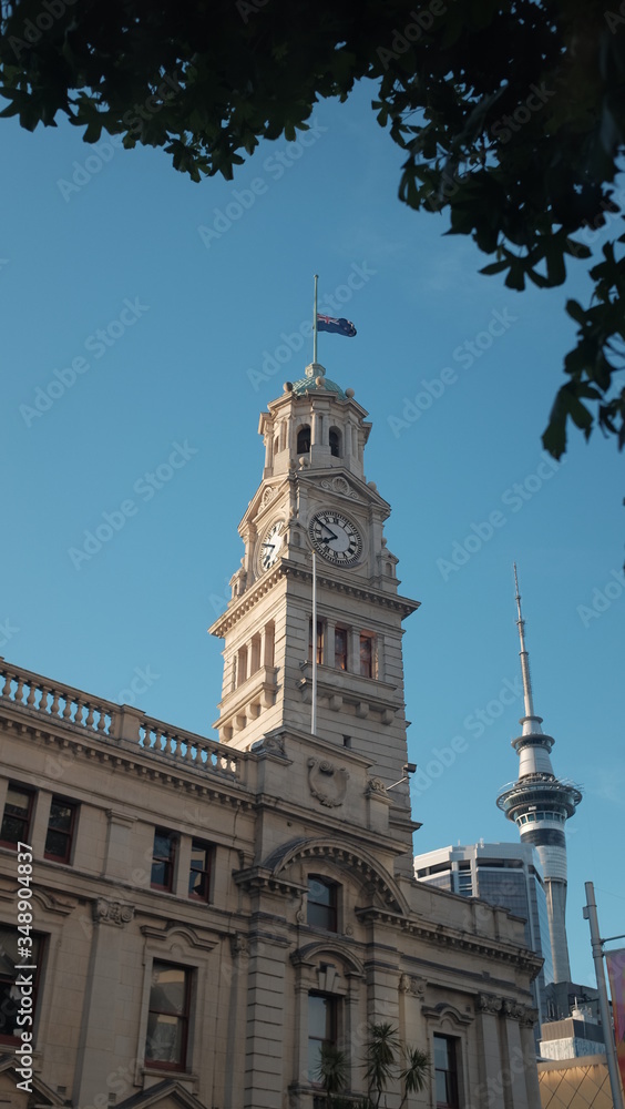 clock tower at the auckland town hall, aotea square under the blue sky and tree shade in New Zealand