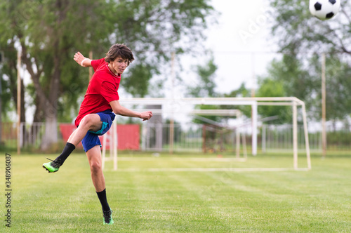 Soccer player kicks ball in a field © Dusan Kostic