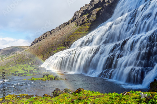 The big and powerful Dynjandi waterfall in the westfjords of Iceland during summer and sunny day. Holiday and travelling concept.