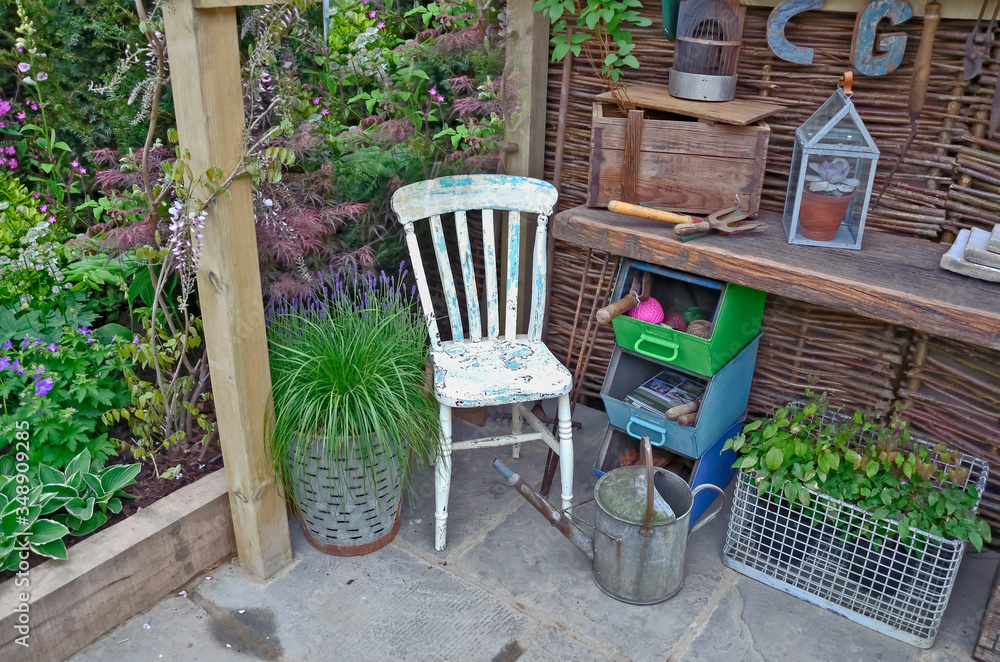Interior of a garden potting shed with plants, tools and seat Interior of a garden potting shed with plants, tools and seat