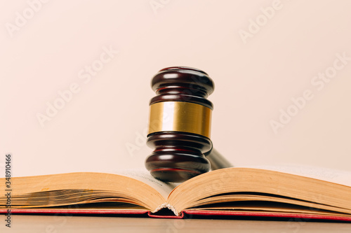 Judge gavel and laws books on a wooden table.