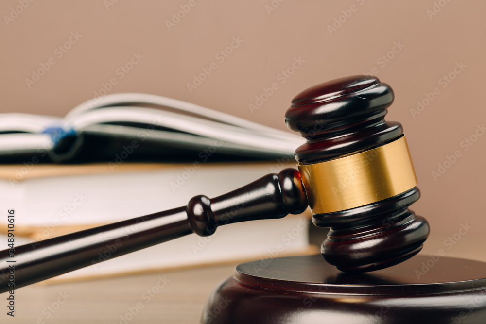 Judge gavel and laws books on a wooden table. Judge gavel and laws books on a wooden table.