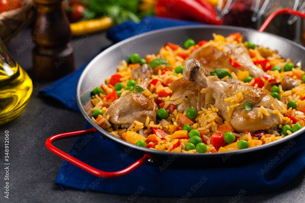 Arroz con pollo. Baked pieces of chicken with bone, rice with paprika and peas. Arroz con pollo. Baked pieces of chicken with bone, rice with paprika and peas.
