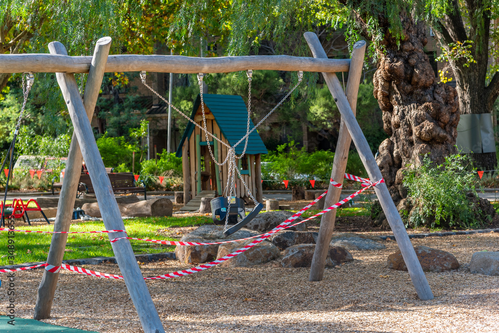 An inner city playground is flagged and signposted as closed during the covid-19 pandemic in Melbourne Australia An inner city playground is flagged and signposted as closed during the covid-19 pandemic in Melbourne Australia