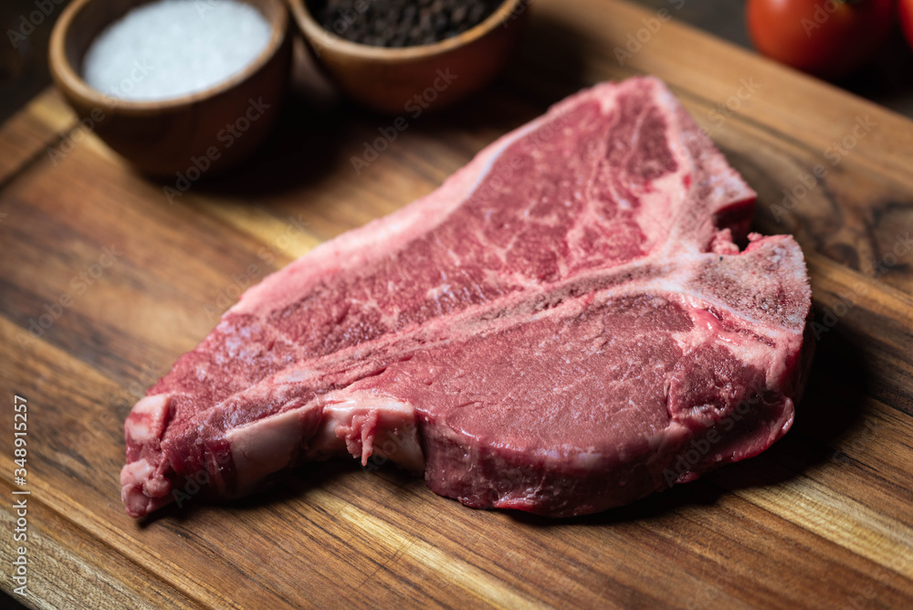 fresh T-Bone steak on wooden cutting board fresh T-Bone steak on wooden cutting board