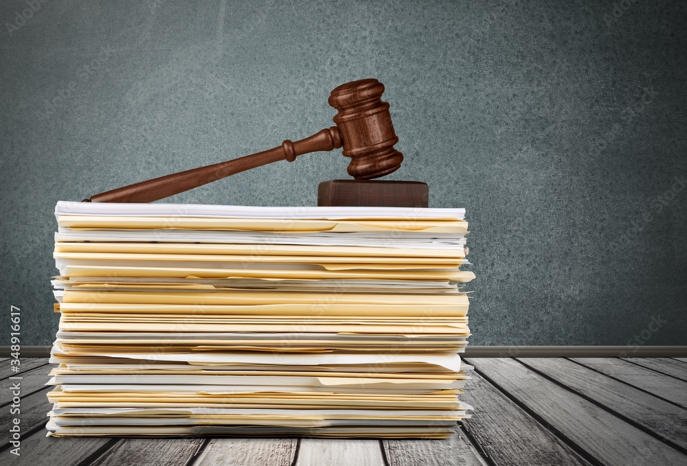 Judge wooden hammer and stack documents Judge wooden hammer and stack documents