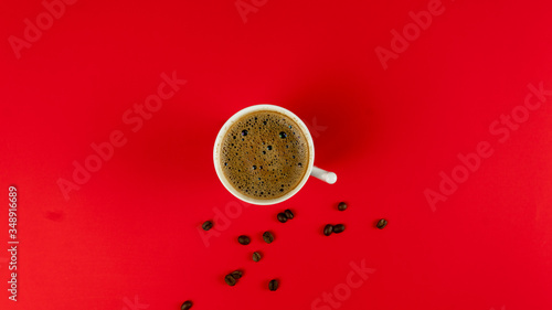 Coffee and coffee beans on a red background