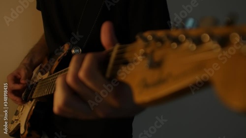 Playing the guitar in low light in slow motion. #1