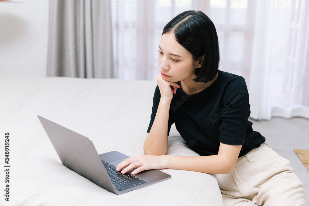 Attractive asian female working with computer laptop at home. Analyzing online data to success business working with computer laptop at home. Work from home concept. Attractive asian female working with computer laptop at home. Analyzing online data to success business working with computer laptop at home. Work from home concept.