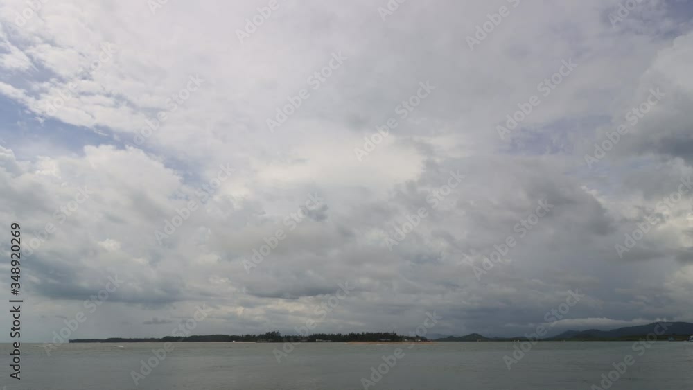 Timelapse of clouds and rain over island and fishing boat Timelapse of clouds and rain over island and fishing boat