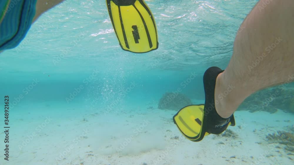 UNDERWATER CLOSE UP: Active male tourist wears flippers to snorkel ...
