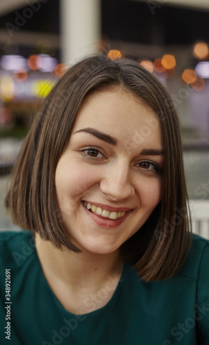 Woman smiling with perfect smile in mall and looking at camera. Image for your stories.