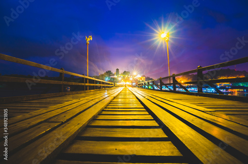 Mon Bridge or Uttamanusorn Bridge at night in Sangkhla Buri, Kanchanaburi, Thailand