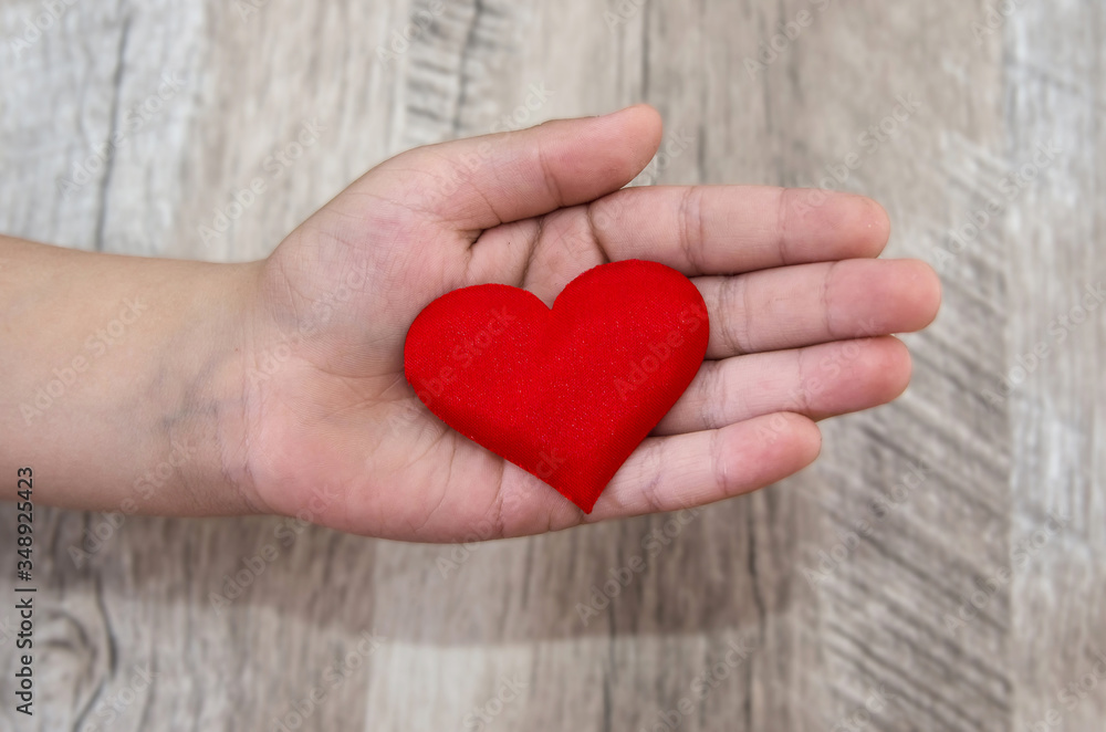 red heart on the palm. View from above. Close-up.